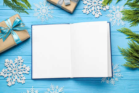 Christmas composition with blank book on color wooden backgroundの写真素材