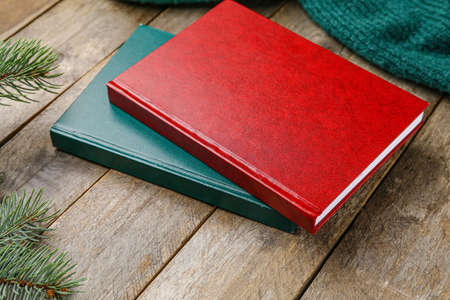 Christmas composition with blank books on wooden background