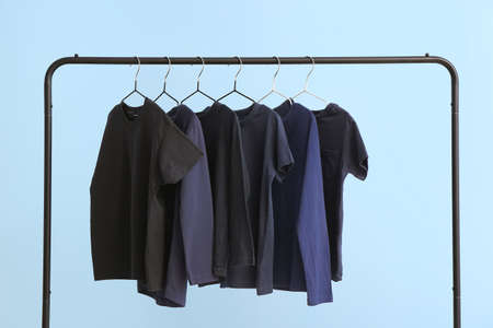 Rack with clothes on color backgroundの写真素材