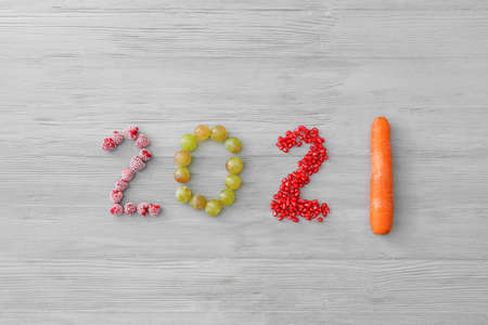 Figure 2021 made of products on wooden background