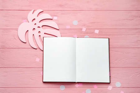 Blank open book on color wooden background
