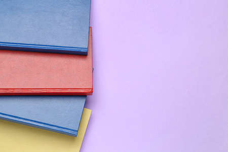 Blank books on color background