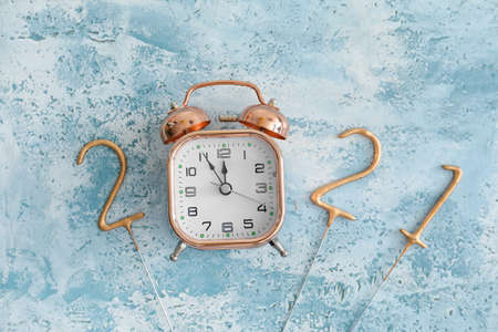 New Year composition with alarm clock on color backgroundの写真素材