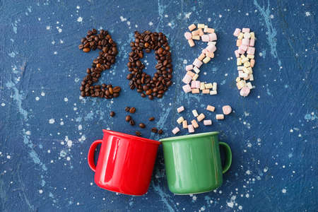 Beautiful New Year composition with cups on color background