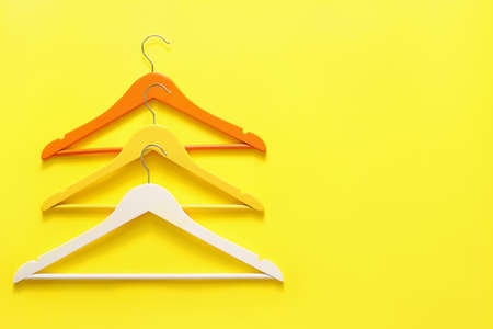 Clothes hangers on color backgroundの写真素材
