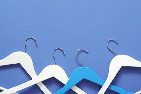 Clothes hangers on color backgroundの写真素材