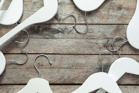 Composition with clothes hangers on wooden backgroundの写真素材