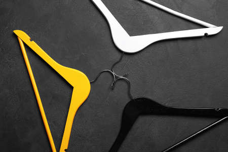 Clothes hangers on dark backgroundの写真素材