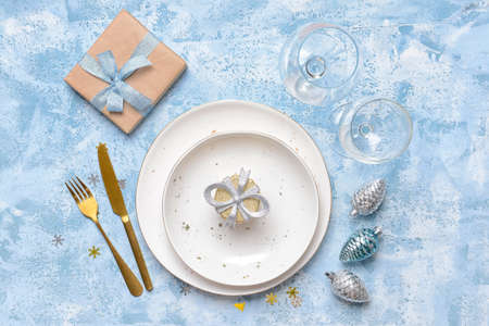 Christmas table setting on color backgroundの写真素材