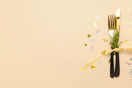 Composition with cutlery for Christmas table setting on color backgroundの写真素材