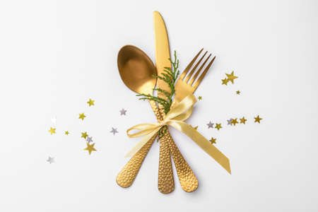 Composition with cutlery for Christmas table setting on white background