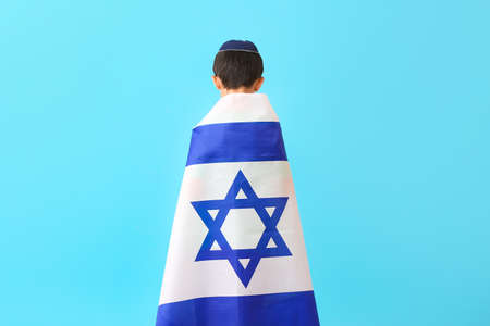 Little boy with the flag of Israel on color backgroundの写真素材