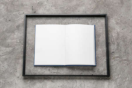 Blank book with frame on grunge background