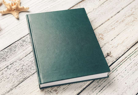 Blank book on white wooden background