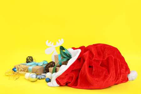Santa Claus bag full of gifts on color backgroundの写真素材