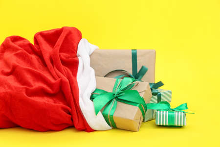 Santa Claus bag full of gifts on color backgroundの写真素材