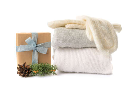 Stylish Christmas clothes with gift on white background