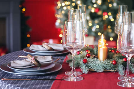 Beautiful table setting with Christmas decorations in living roomの写真素材