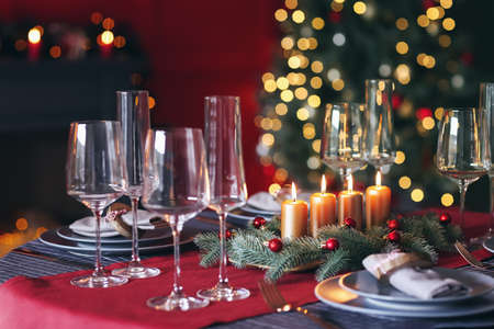 Beautiful table setting with Christmas decorations in living roomの写真素材