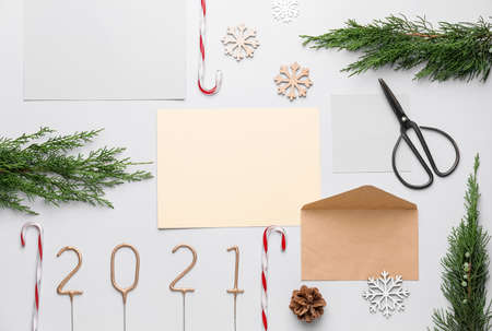 Beautiful New Year composition with blank card and envelope on white background