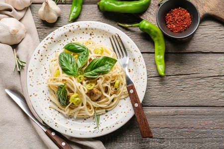 Plate with tasty noodles and chicken on wooden backgroundの写真素材