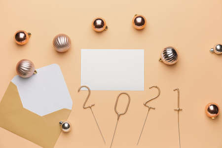 Beautiful New Year composition with blank card and envelope on color background