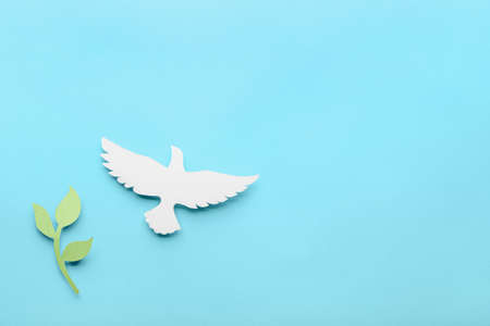 Paper dove and olive branch on color background. International Day of Peaceの写真素材