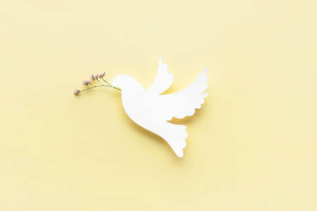Paper dove on color background. International Day of Peaceの写真素材