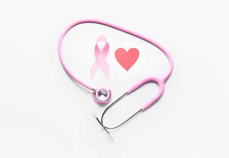 Pink ribbon, heart and stethoscope on light background. Breast cancer awareness conceptの写真素材