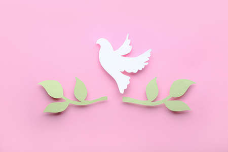 Paper dove and olive branches on color background. International Day of Peaceの写真素材