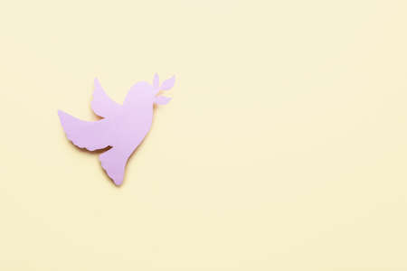 Paper dove on color background. International Day of Peaceの写真素材