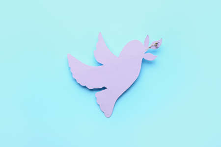 Paper dove on color background. International Day of Peaceの写真素材