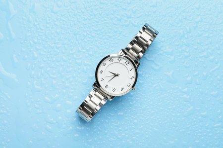 Wrist watch on color background