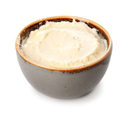 Bowl with tasty cream cheese on white backgroundの写真素材