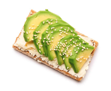 Crispbread with tasty cream cheese and avocado on white background