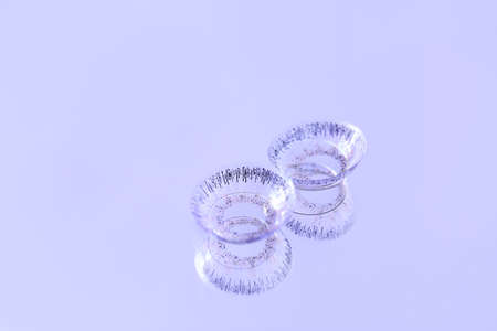 Contact lenses on color backgroundの写真素材
