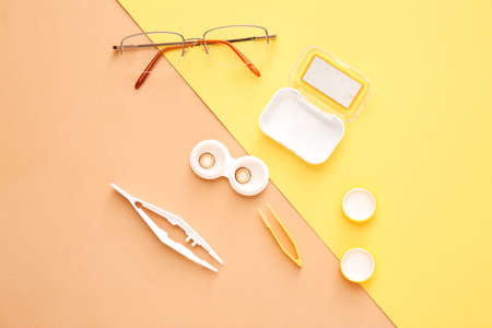 Composition with contact lenses and accessories on color background
