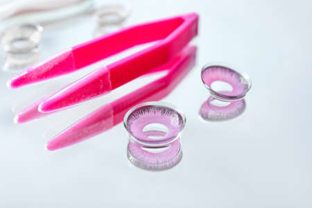 Contact lenses and tweezers on light backgroundの写真素材