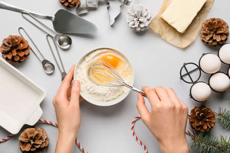 Woman preparing dough on light backgroundの写真素材