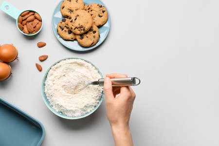 Woman preparing dough on light backgroundの写真素材