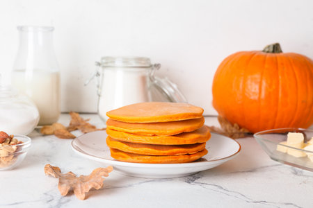 Tasty pumpkin pancakes on tableの写真素材