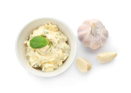Bowl with tasty garlic butter on white backgroundの写真素材