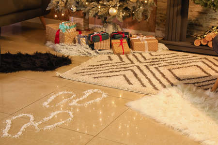 Footprints of Santa on floor in room decorated for Christmasの写真素材