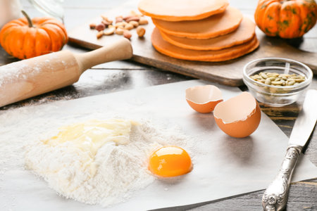 Ingredients for preparing tasty pumpkin pancakes on table