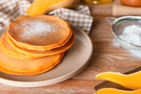 Tasty pumpkin pancakes on tableの写真素材