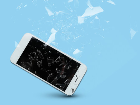 Mobile phone with cracked glass screen on color backgroundの写真素材