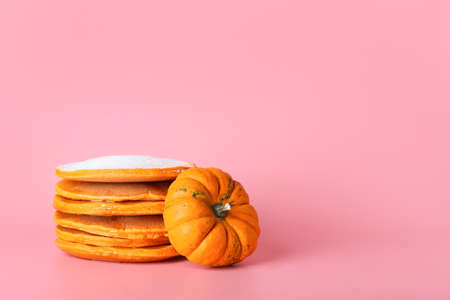 Tasty pumpkin pancakes on color backgroundの写真素材