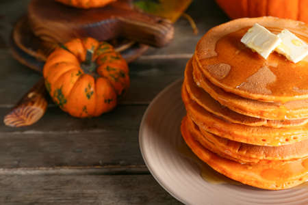Tasty pumpkin pancakes on tableの写真素材