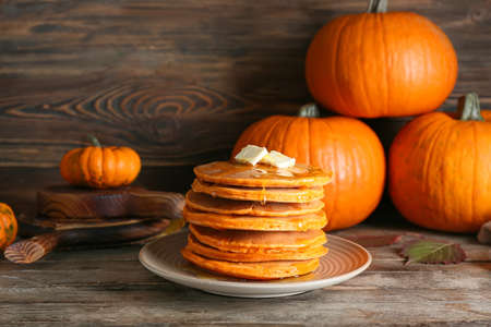 Tasty pumpkin pancakes on tableの写真素材