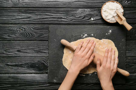 Woman preparing bakery on table, top view